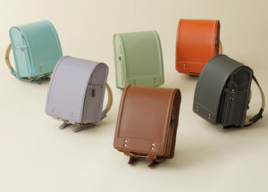 Picture of six different randoserus, stiff sided backpacks that are a custom in Japanese educational tradition.