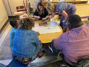 Picture from the Montessori Experience event with teachers taking instruction from other Montessori leaders in the state