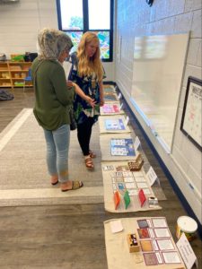 Picture from Montessori Experience event of two educators looking at Montessori resources for the classroom